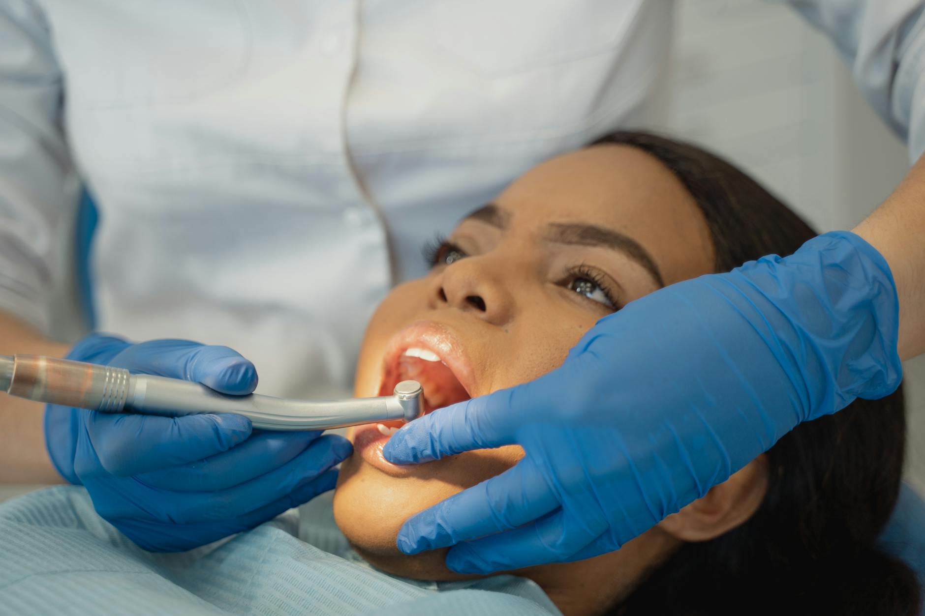 dentist using dental grinder on a patient